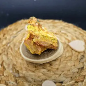 Photo d'une pierre Orpiment aux reflets dorés, utilisée pour stimuler les organes et renforcer le système immunitaire et nerveux.
